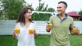 summer, in the garden, parents, mom and dad, carry freshly squeezed fruit juice to treat their children. The family Royalty Free Stock Photo