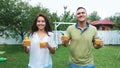 summer, in the garden, parents, mom and dad, carry freshly squeezed fruit juice to treat their children. The family Royalty Free Stock Photo