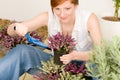 Summer garden terrace redhead woman potted flower Royalty Free Stock Photo