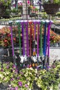 Summer garden watering wands and sprayers on display in garden center surrounded by flowers in pots Royalty Free Stock Photo