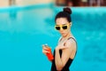 Summer Girl Applying Suncream Lotion by the Pool Royalty Free Stock Photo