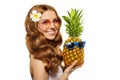 Summer girl Bright woman with a pineapple in her hands with earrings in the form of a tropical leaf, with sun glasses on a white