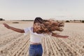 Summer Girl enjoying nature on yellow field. Beautiful young woman dancing Outdoors. Long hair in the wind. Happiness and Royalty Free Stock Photo