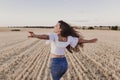 Summer Girl enjoying nature on yellow field. Beautiful young woman dancing Outdoors. Long hair in the wind. Happiness and Royalty Free Stock Photo