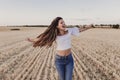 Summer Girl enjoying nature on yellow field. Beautiful young woman dancing Outdoors. Long hair in the wind. Happiness Royalty Free Stock Photo