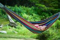 Summer girl in hammock conversating by cell phone Royalty Free Stock Photo