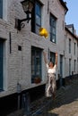 Summer girl jumping yellow hat white house Royalty Free Stock Photo