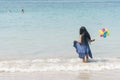 Summer girl play travel in holiday on tropical summer beach. Cheerful Joyful seaside with cute kid vacation on sunny day Royalty Free Stock Photo