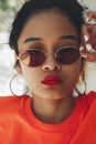 Asian woman posing on sunny summer or spring day outside. Vertical shot.