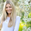 Summer girl portrait. Beautiful blonde woman smiling on sunny summer or spring day outside on a meadow Royalty Free Stock Photo