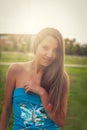 Summer girl portrait in park. European woman smiling happy on sunny summer or spring day outside in park backlit, shot Royalty Free Stock Photo