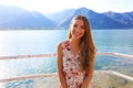 Summer girl portrait. Young woman smiling happy on sunny summer or spring day outside on lake. Pretty young woman outdoors.