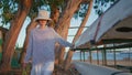 Summer girl resting camp evening at riverside. Carefree woman touching canoe Royalty Free Stock Photo