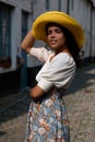 Summer girl yellow hat street white house Royalty Free Stock Photo