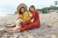 Summer. Girls With Dog On Beach. Fashion Women In Boho Dresses And Straw Hat With Pet On Dog-Friendly Resort Royalty Free Stock Photo