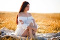 Summer is a great dream time. Sunny summer portrait of a beautiful young woman in the middle of a field Royalty Free Stock Photo