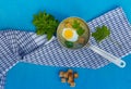 Summer green soup of wild grass aegopodium with boiled egg and crackers in a ladle, top view Royalty Free Stock Photo