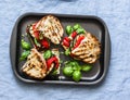 Summer grilled vegetables sandwiches. Eggplant, bell peppers, ciabatta, yogurt sauce, basil sandwiches in baking sheet on blue bac