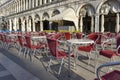 summer ground in St. Marks Square: an empty red and yellow seats in summer area restaurant