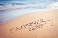 Summer 2015 handwriting on a sandy beach. Royalty Free Stock Photo