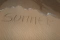 summer handwritten on sand, summer background, sea and sand background