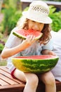 Summer happy child girl eating watermelon outdoor on vacation Royalty Free Stock Photo