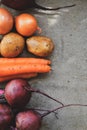 Summer harvest. Beets, potatoes, carrots and onions on a concrete background. Whole raw vegetables, ingredients for soup Royalty Free Stock Photo