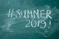 Summer 2019 hashtag it handwritten with white chalk on a green blackboard Royalty Free Stock Photo