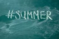 Summer hashtag it handwritten with white chalk on a green blackboard Royalty Free Stock Photo