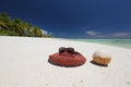 Summer hat and coconut on tropical sandy beach Royalty Free Stock Photo