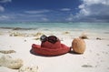 Summer hat and coconut on tropical sandy beach Royalty Free Stock Photo