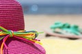 Summer hat and flip flops on a beach Royalty Free Stock Photo