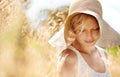 Summer, hat and wheat with woman in field for travel, vacation and holiday. Thinking, peace and nature with female