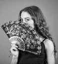 Summer heat. Fresh air. Kid girl fanning herself with fan. Air circulation. Mysterious vintage girl. Cooling and Royalty Free Stock Photo