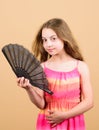 Summer heat. Fresh air. Kid girl fanning herself with fan. Cooling and ventilation. Conditioning system. Climate control Royalty Free Stock Photo