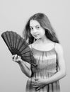 Summer heat. Fresh air. Kid girl fanning herself with fan. Cooling and ventilation. Conditioning system. Climate control Royalty Free Stock Photo