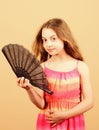 Summer heat. Fresh air. Kid girl fanning herself with fan. Cooling and ventilation. Conditioning system. Climate control