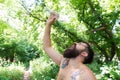 Summer heat. Man thirsty sweaty hipster naked in forest. Heat concept. Bearded tattooed guy relax in nature hot summer