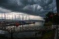 A thunderstorn is emerging over a small port at lake constance Royalty Free Stock Photo