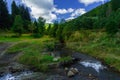 Summer highland green hills and river stream June warm time day season landscape idyllic scenery view Royalty Free Stock Photo