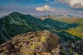 Summer hiking in the mountains with massive rocks, dramatic skies and majestic mountains. Royalty Free Stock Photo