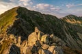 Summer hiking in the mountains with massive rocks, dramatic skies and majestic mountains. Royalty Free Stock Photo