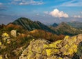 Summer hiking in the mountains with massive rocks, dramatic skies and majestic mountains. Royalty Free Stock Photo