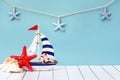 Summer holiday background. Sea card with ship, sand, shells and starfish on blue background top view. Vacation season Royalty Free Stock Photo