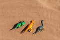 Summer or holiday beach vacation background, travel to the sea with kids. Ocean coast with sand and dinosaur plastic Royalty Free Stock Photo