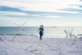 Summer holiday. Child chasing birds near summer beach. Excited boy running on the beach with flying seagulls birds.