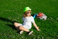 Summer holiday with children. Cute kid boy relaxing on meadow. Happy child playing in summer park. Little boy resting in