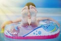 Summer holiday is comming. Happy little child girl playing in water with colorful child boat Royalty Free Stock Photo