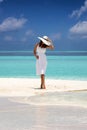 Attractive woman stands on a sandbank with turquoise waters and blue sky Royalty Free Stock Photo