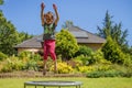 Summer holiday concept. Little very happy cute child girl enjoys jumping on trampoline. Horizontal image Royalty Free Stock Photo